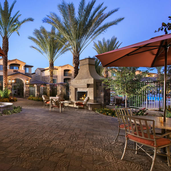 Patio area with fireplace outside of San Portales in Scottsdale, Arizona