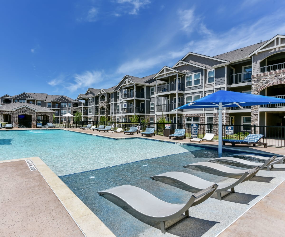 Resort-style swimming pool at Cottages at Abbey Glen Apartments in Lubbock, Texas