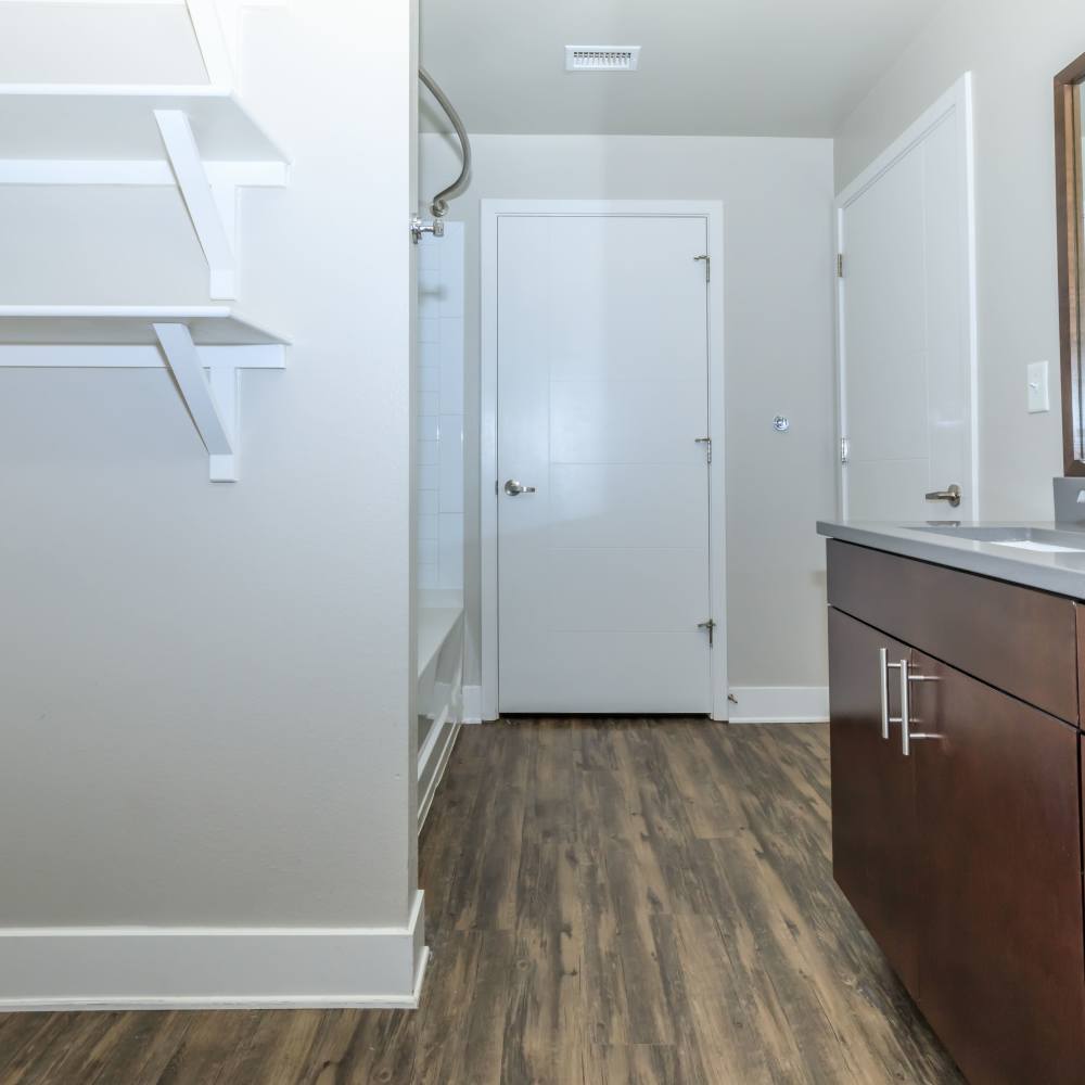 Bathroom with sink, storage are and wood-style flooring at Park Place Olde Town Apartments in Arvada, Colorado