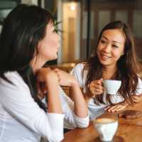 Two coffee cups on a wooden table at The Billie in Baltimore, Maryland