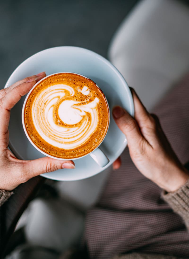 Resident enjoying a latte at Marquis at the Reserve in Katy, Texas