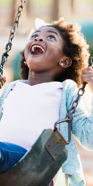 Child paying at park near The Fountains of Preston Hollow in Dallas, TX