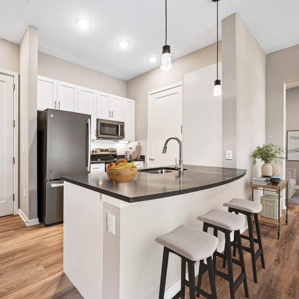 Kitchen with white cabinetry and barstool at Neo Vantage Point in Maryland Heights, Missouri