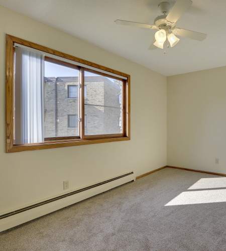 Bedroom of apartment with window at Fountain Terrace in New Brighton, Minnesota