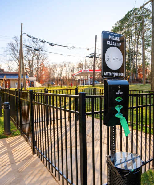 A resident and her dog walking at a park near 5 Row in Charlottesville, Virginia
