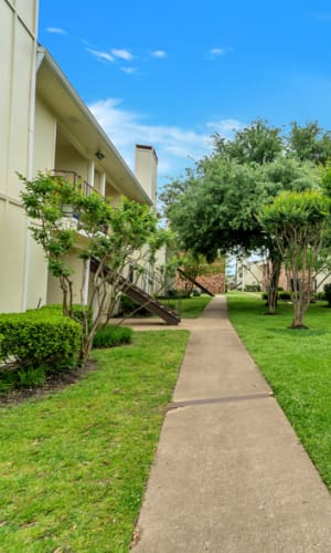 Walking path through the grounds at Stonegate Apartments in Mckinney, Texas