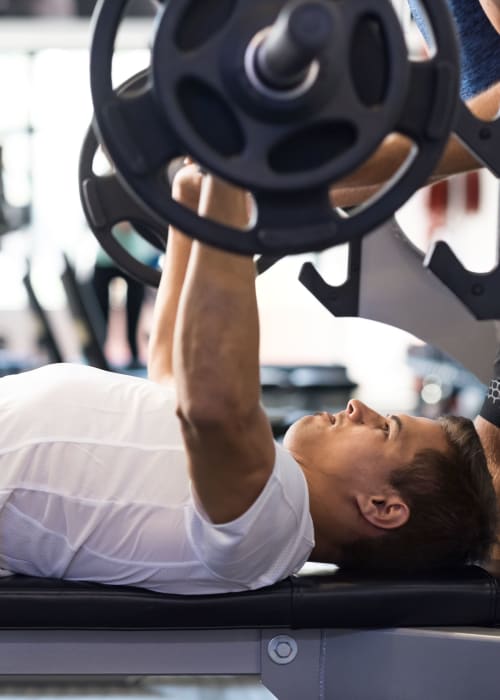 Resident lifting weights at RISE on Apache in Tempe, Arizona