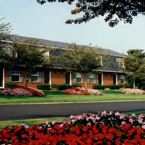 Exterior and professionally landscaped grounds with flowers in full bloom at Pointe at Northern Woods, Columbus, Ohio