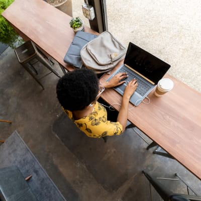 A woman using her laptop in a coffee shop near Thirty - One 32 Cypress in Hoover, Alabama