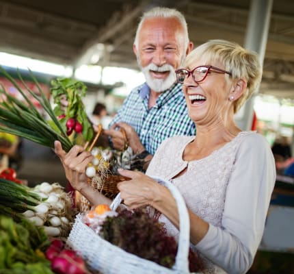 Residents buying produce at a farmer's market near Emerald Park Apartment Homes in Dublin, California