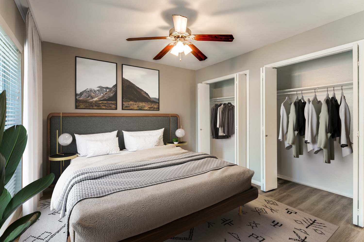 Hardwood-style flooring in a model home's bedroom at Tribecca Pointe Apartments in Hurst, Texas