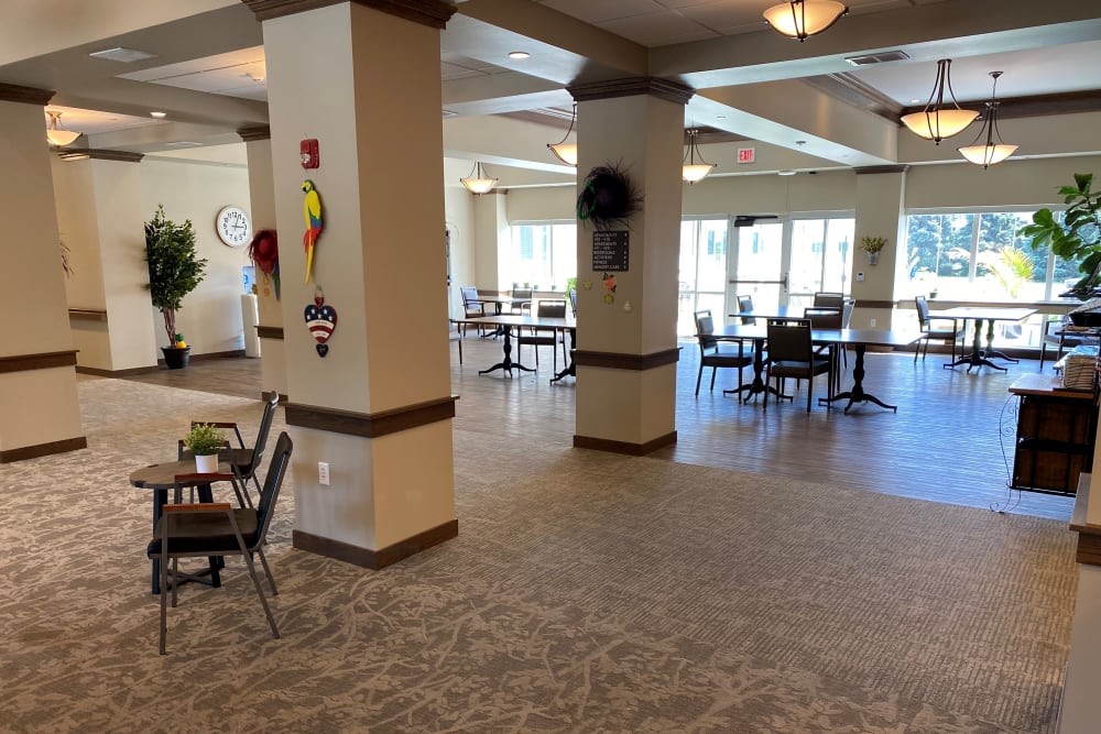 Common space with bright windows and tables at Country Meadow Place in Mason City, Iowa