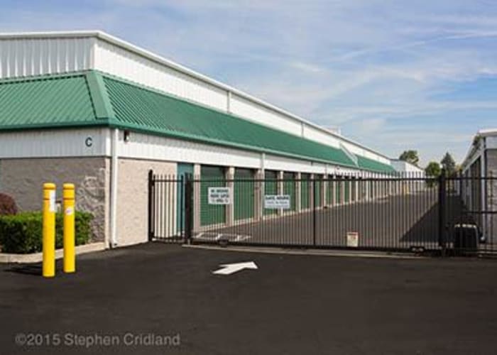 Outdoor storage units with green doors and wide driveways at A Storage Place in Albany, Oregon