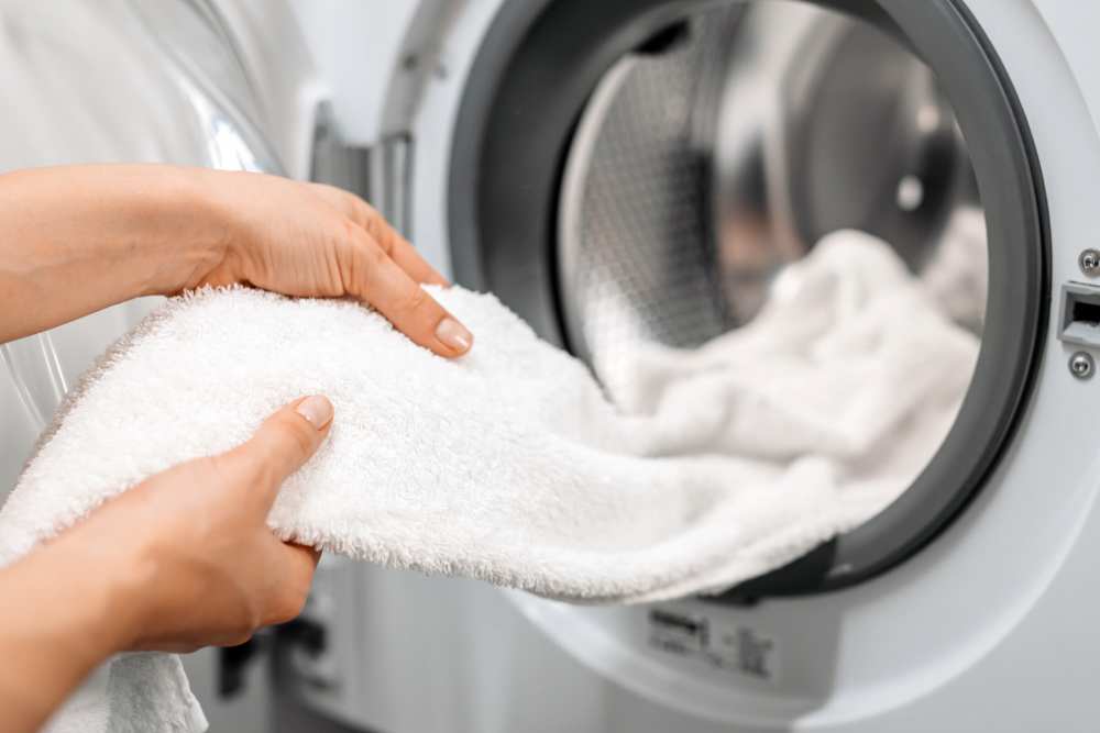 Hands holding a white towel from a dryer at Stonehurst Manor and Harrison Court in Upper Darby Township, Pennsylvania