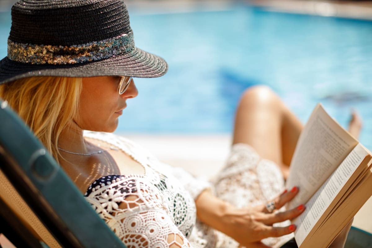 Reading a book by the pool at 33Hundred in Austin, Texas