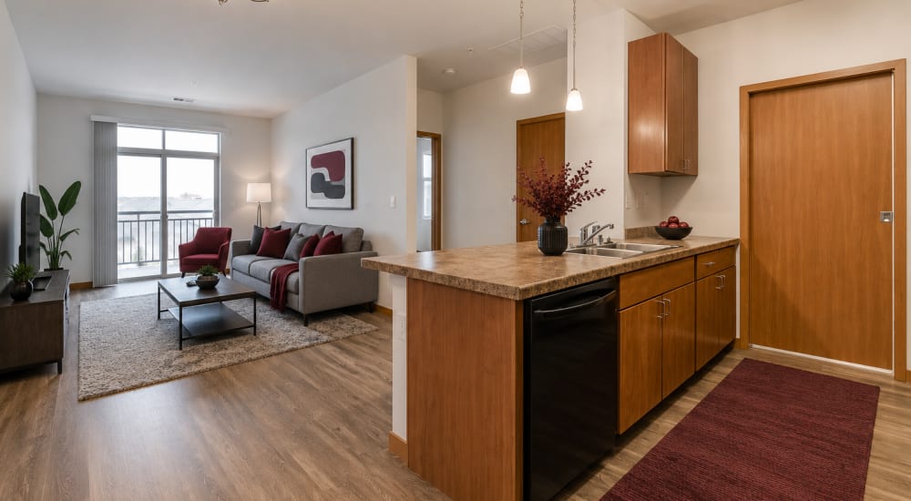 Cozy living room with large windows at Layton Square in Cudahy, Wisconsin