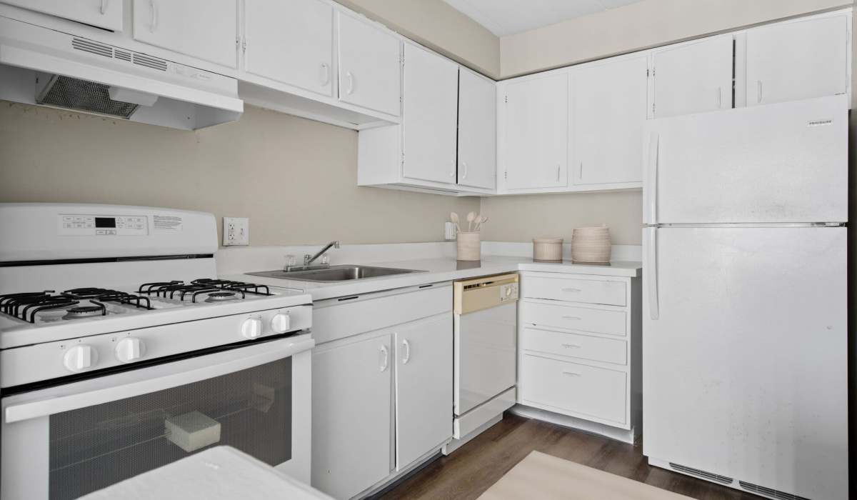 Spacious kitchen with white cabinets at Granada Gardens Apartments in Warrensville Heights, Ohio