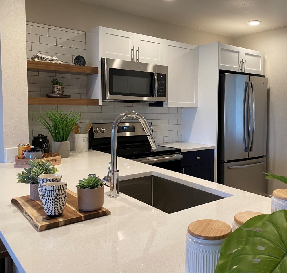 Chef-inspired kitchen with quartz countertops in a model home at Harbor Point Apartments in Mill Valley, California