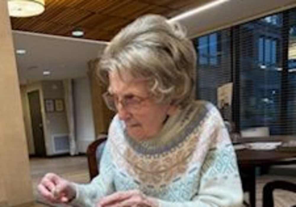 Resident sitting at the community dinning room at Merrill Gardens at Wright Park in Tacoma, Washington