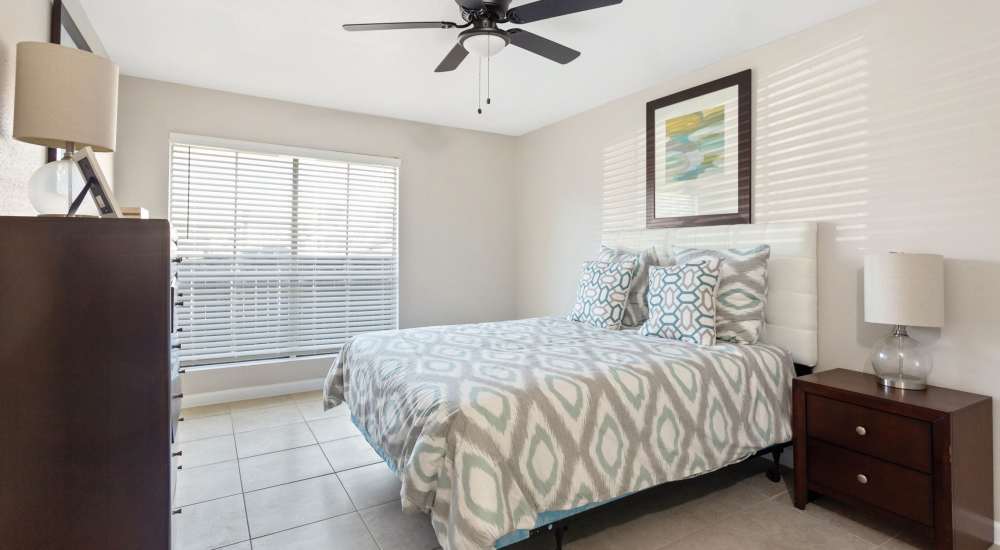 Bedroom with a bed and dresser at The Alora Apartments in Houston, Texas