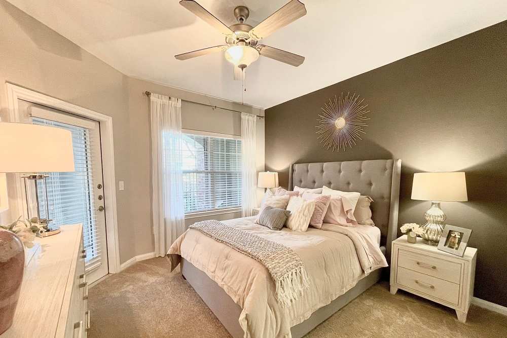 Cozy apartment bedroom with a king size bed at The Abbey at Barker Cypress in Houston, Texas