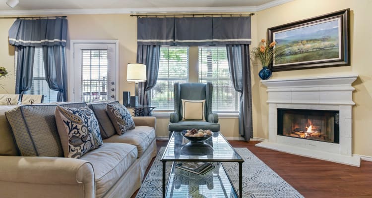 Open-floor concept with wood-style flooring at Ranch ThreeOFive in Arlington, Texas