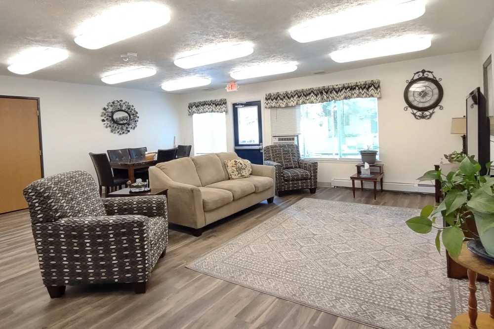 Community clubhouse with couches and lights at Willow Creek Apartments in Escanaba Michigan