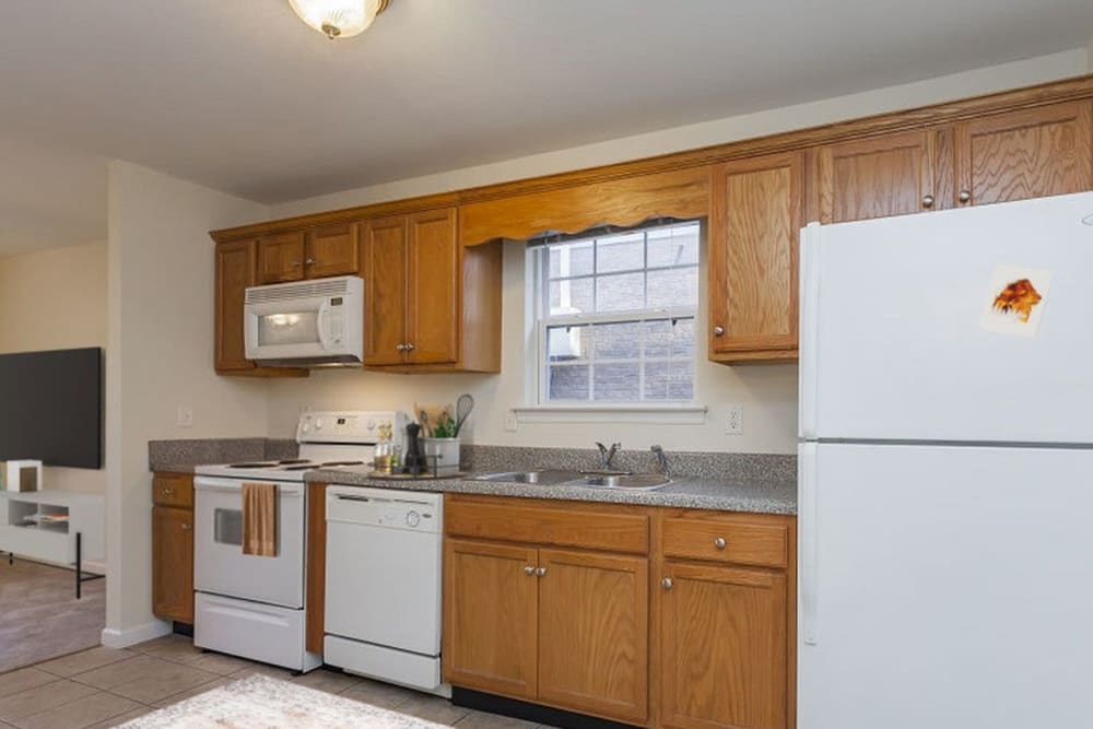 Kitchen with wood cabinets at Home Place Apartments in East Ridge, Tennessee