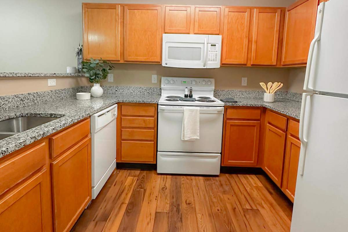 Modern kitchen with white appliances at Cushendall Commons in Rock Hill, South Carolina