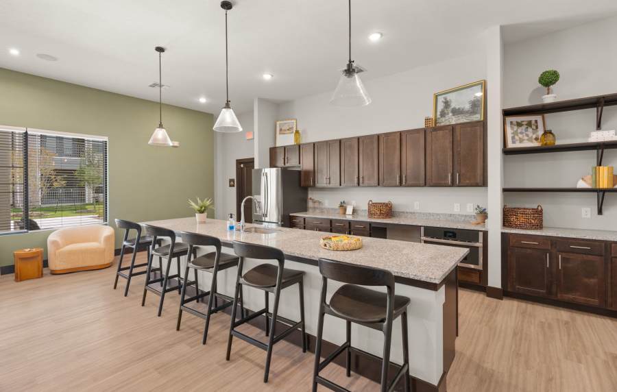 Resident lounge with kitchen area at Walnut Springs in Seguin, Texas
