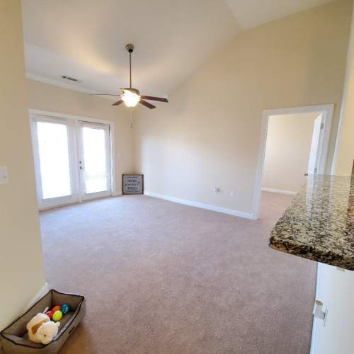 Unfurnished living room with celing fan at Groves at Peach Orchard in Belmont, North Carolina