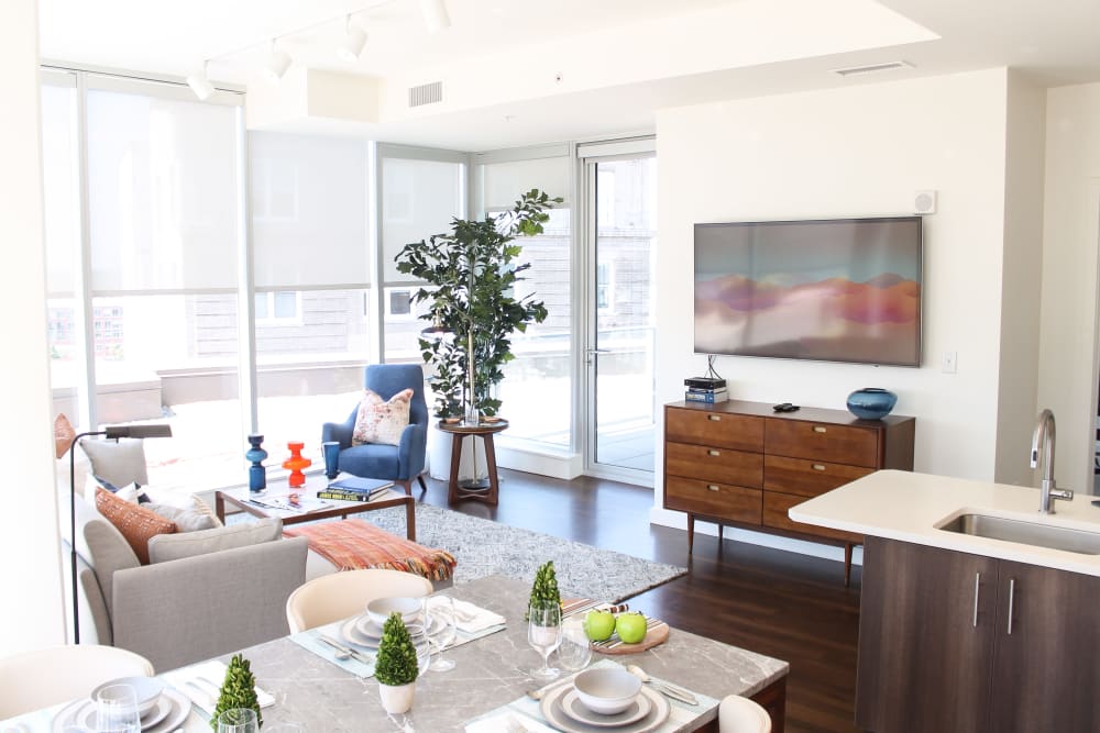 Dining area and model living room with floor-to-ceiling windows at One City Center in Durham, North Carolina