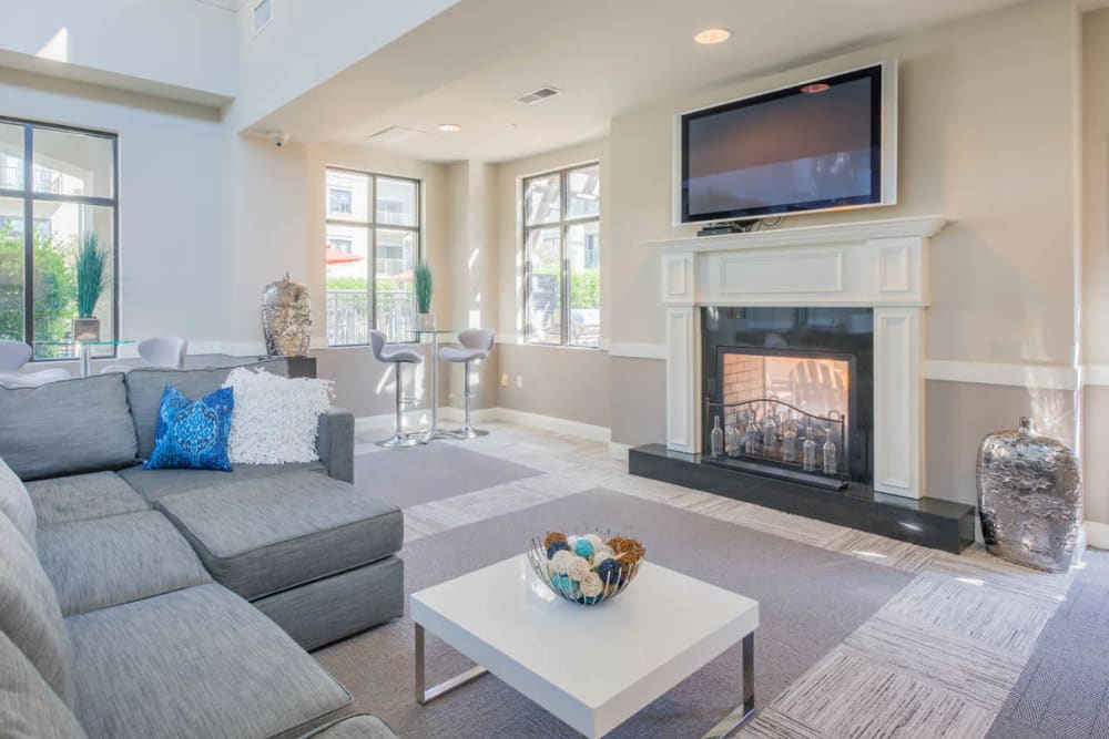 Inviting modern clubhouse with a fireplace and large screen TV at SouthPark Morrison in Charlotte, North Carolina