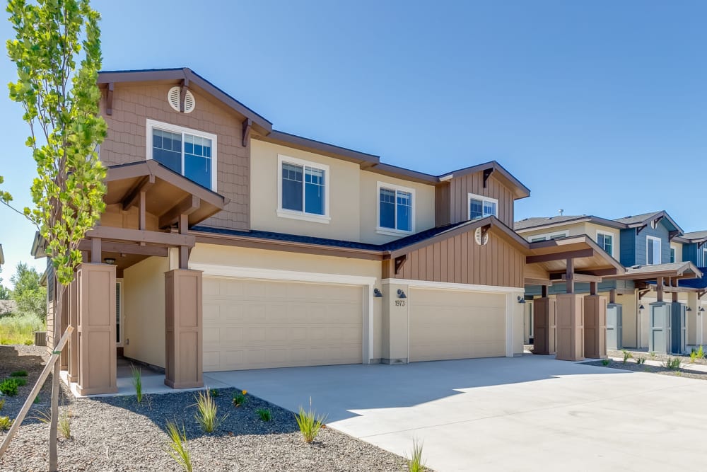 Exterior of two-story, craftsman-style townhomes at Olympus at Ten Mile in Meridian, Idaho