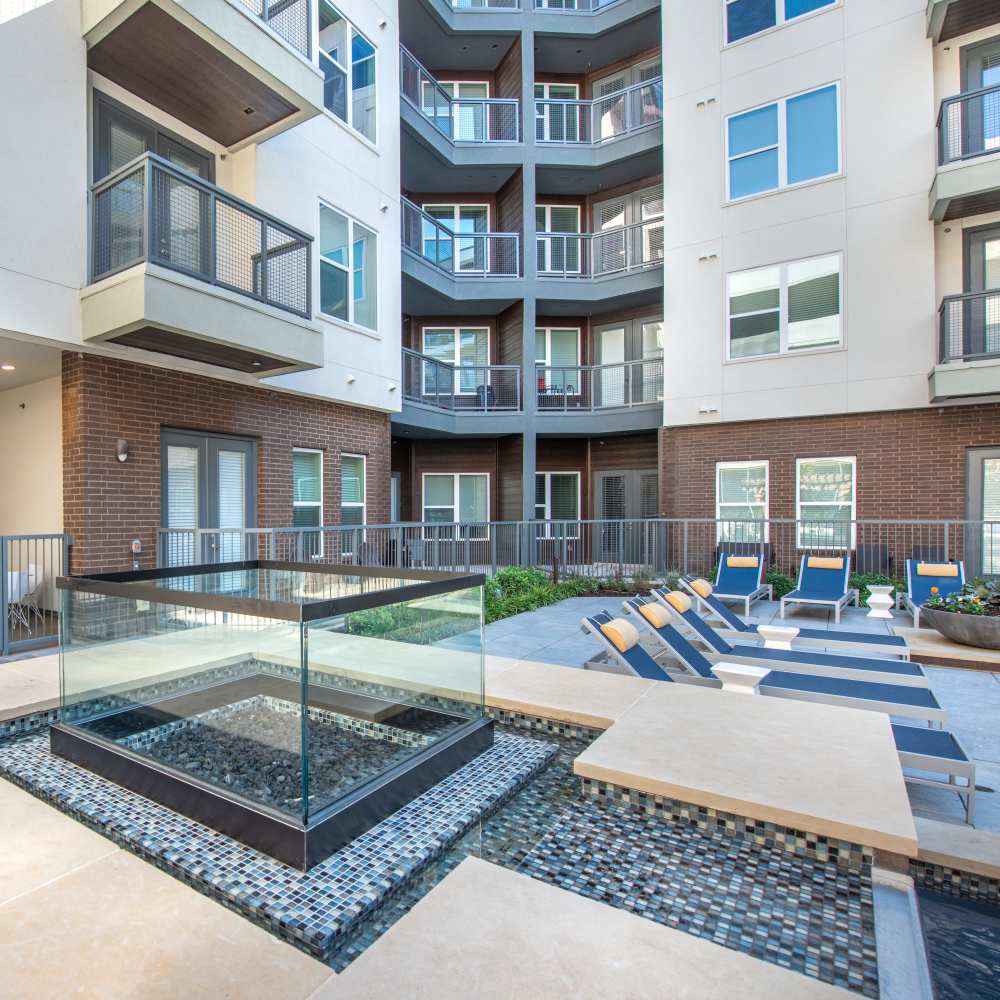 Luxurious tanning shelfs in the pool area at Hall Street Flats in Dallas, Texas