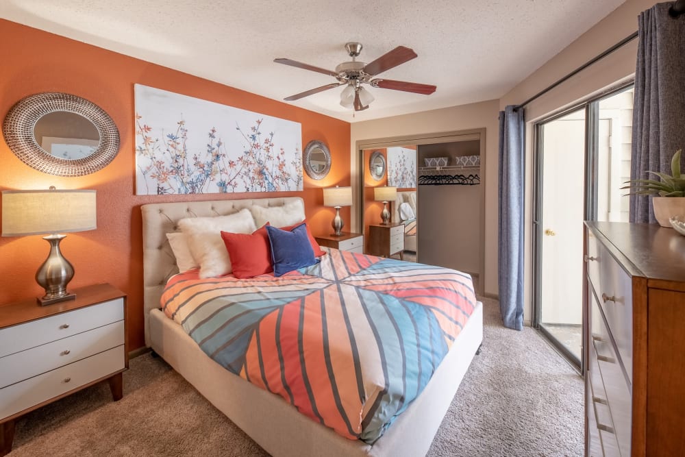 Well-lit bedroom with porch access at Ridgeview Place in Irving, Texas
