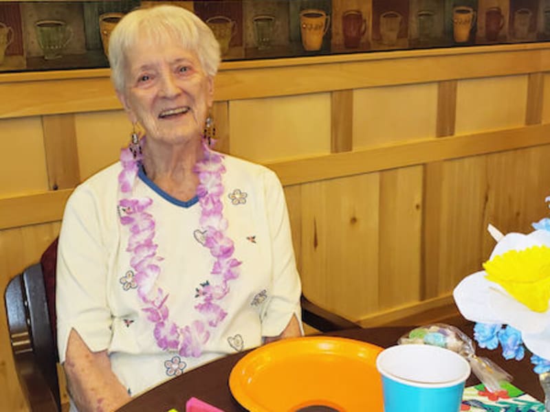A smiling resident enjoying a celebration at Majestic Rim Retirement Living in Payson, Arizona.