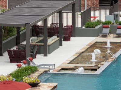 Patio table and fire place near the pool at Anatole at the Pines in Conroe, Texas