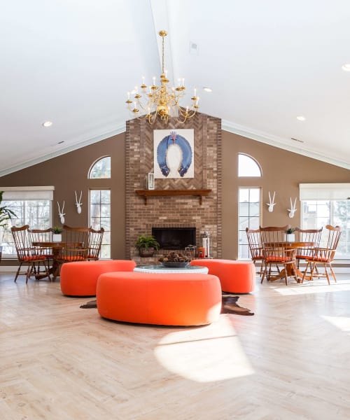 Clubhouse with a fireplace and well-appointed kitchen at Saddle Creek Apartments in Novi, Michigan