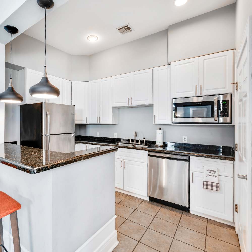 Open kitchen with refrigerator at The Boulders At Katy Trail in Saint Charles. MO