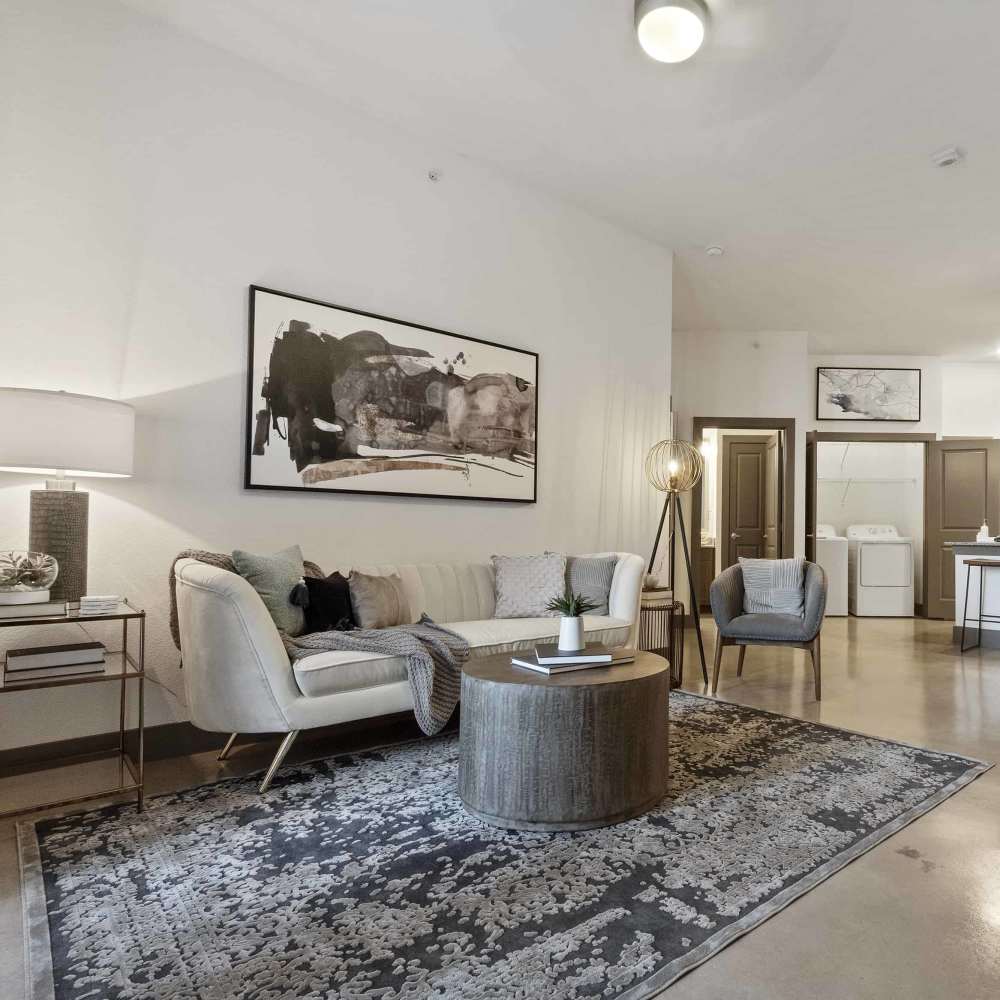 Spacious living room with a couch and wall painting at Millennium Place in Corinth, Texas