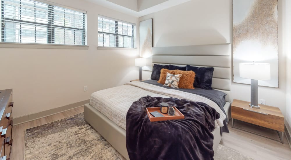 Large furnished bedroom with multiple windows at Bellrock Bishop Arts in Dallas, Texas