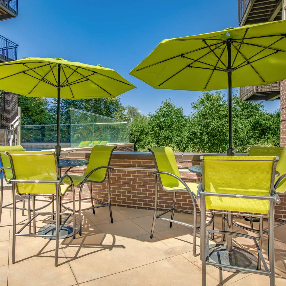 Seating area with umberala stand at Park Place Olde Town Apartments in Arvada, Colorado