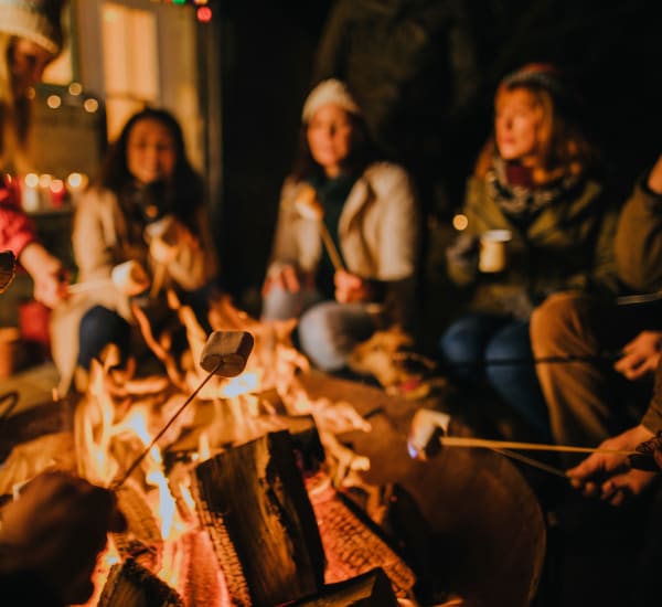 Friends roasting smores near Aviator West 7th in Fort Worth, Texas