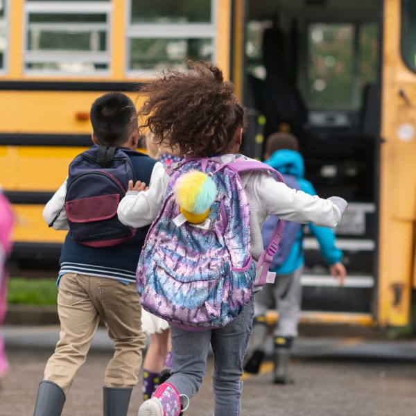 Kids loading the school bus at Windmill Terrace in Bedford, Texas