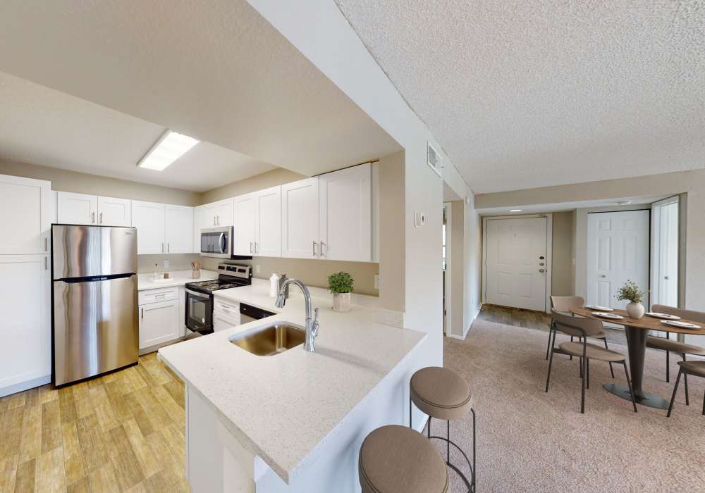 Kitchen with refrigerator and breakfast bar at Cypress Run in Orlando, Florida