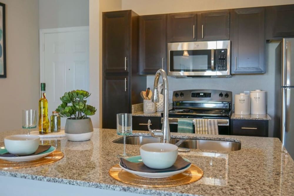 Kitchen island and sink at Biltmore at the Park in Pflugerville, Texas