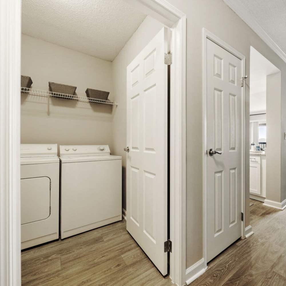 Hallway with laundry room at The Eva in Sandy Springs, Georgia