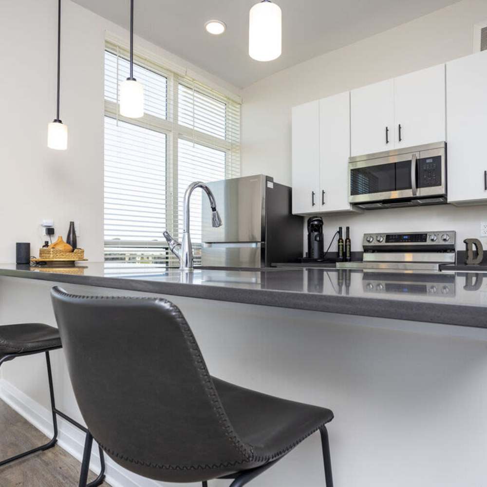 Kitchen island with chairs at The Sutton in , Ohio