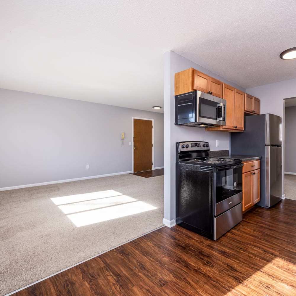 Combined view of kitchen and living room at Oakwood Manor Apartments in Fairport, New York
